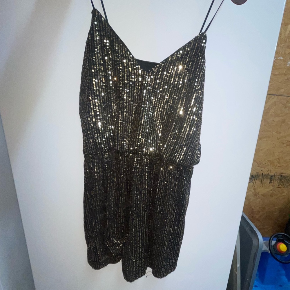 Black and gold sequence romper.